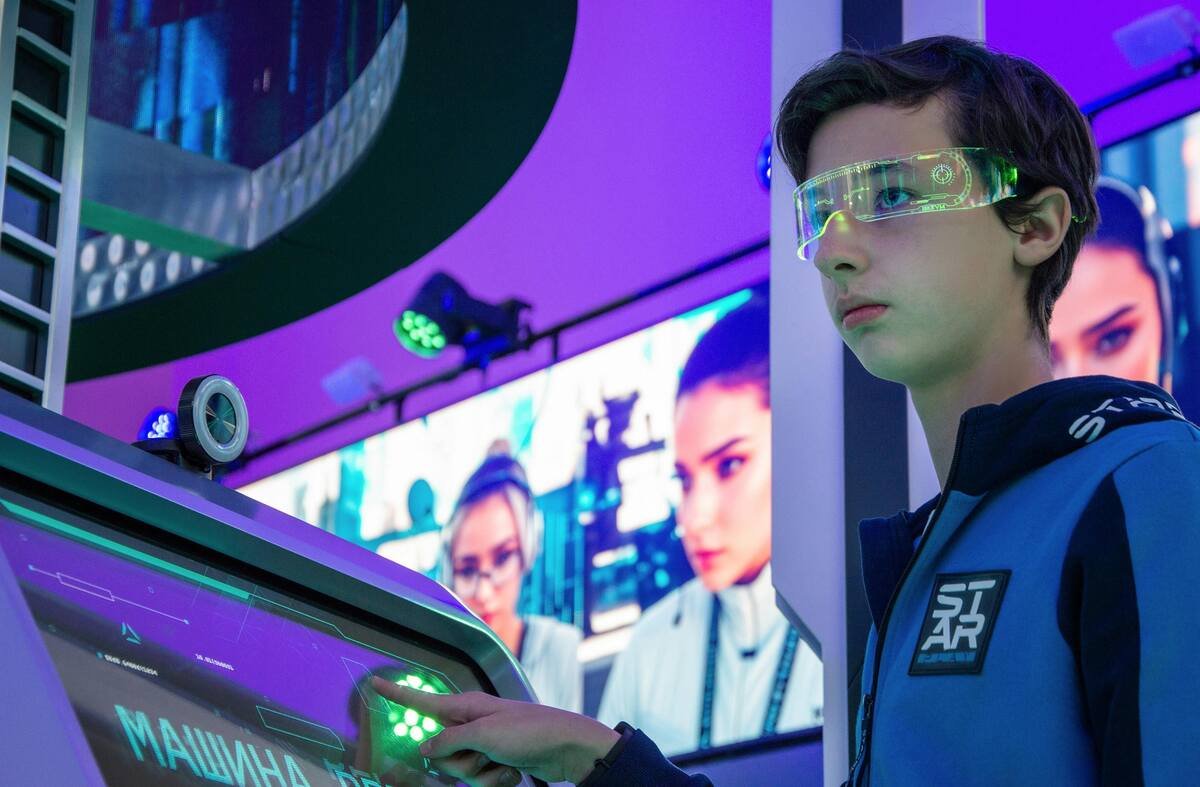 Young person interacting with futuristic technology on a screen, wearing holographic glasses in a digital environment by WorldWideScienceStories.com