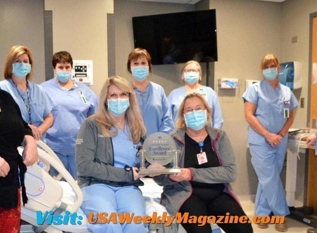 Catholic Health North Jerusalem Wantagh Billing - Medical staff holding an Excellence Award in a hospital setting