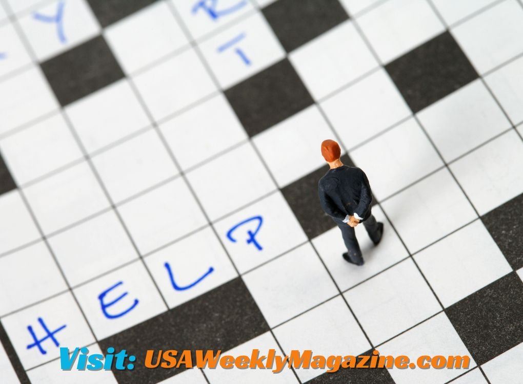 Man standing next to a crossword puzzle with the word 'help' from the San Francisco Examiner NYT