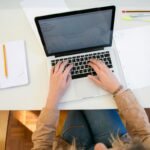 Student preparing for Pace University Algorithm Master final exam questions on a laptop at a clean desk with notebooks and pens