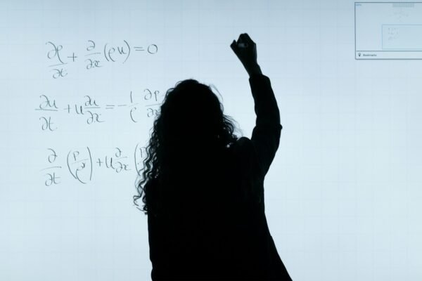 Ms. Bowers writing math equations on a whiteboard at Eagle Elementary, illustrating her hands-on teaching style referenced in the ms bowers eagle elementary review